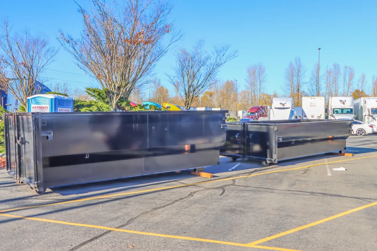 Professional dumpster rental service with roll-off container on residential driveway in Hannibal